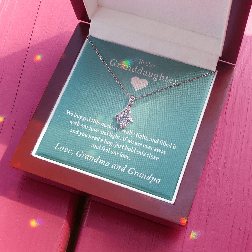 To Our Granddaughter - Feel Our Love ( Grandma and Grandpa) | Stainless Steel and Gold Ribbon Necklace